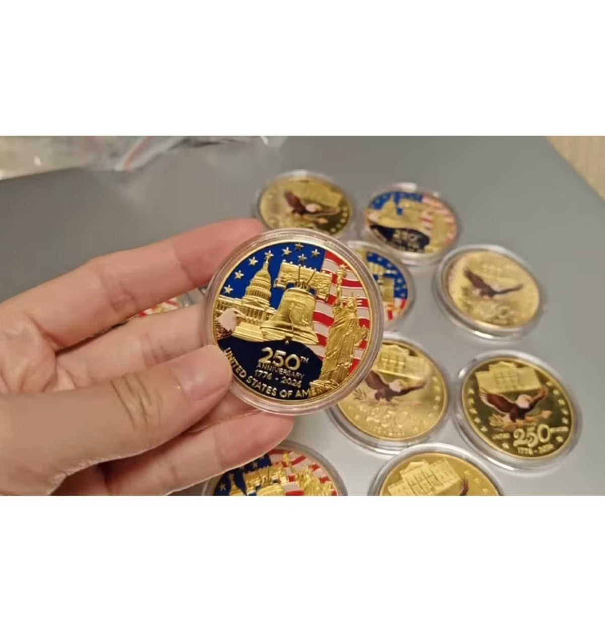 America 250 Challenge Coin front design close-up with Liberty Bell, U.S. Capitol, Statue of Liberty and American flag