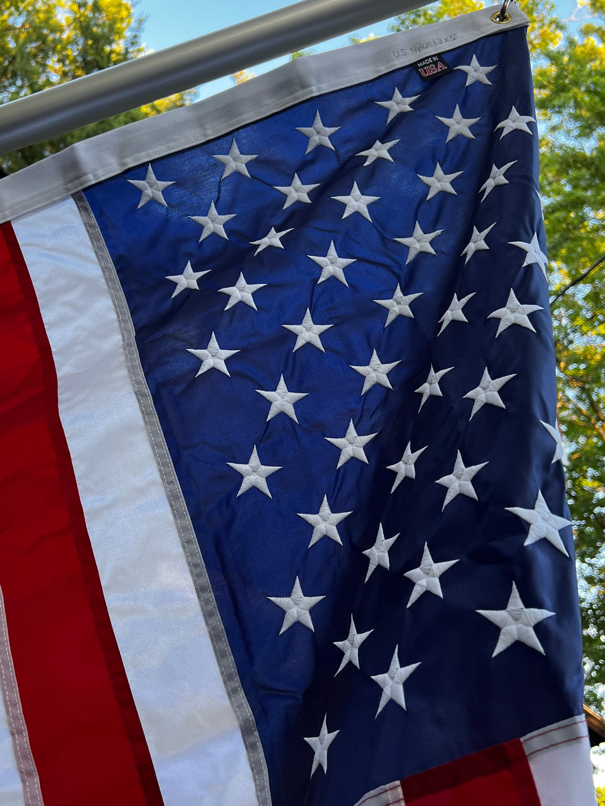 Large nylon American flag in red, white, and blue, featuring stars and stripes, by Atlantic Flag & Pole Inc.