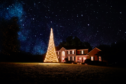 Warm white LED Christmas tree for flagpole, illuminated at night, featuring a festive design. By Atlantic Flagpole.